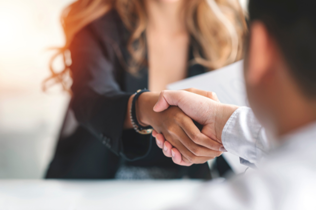 Business woman shaking hands