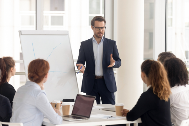 Business man leading team, conference table